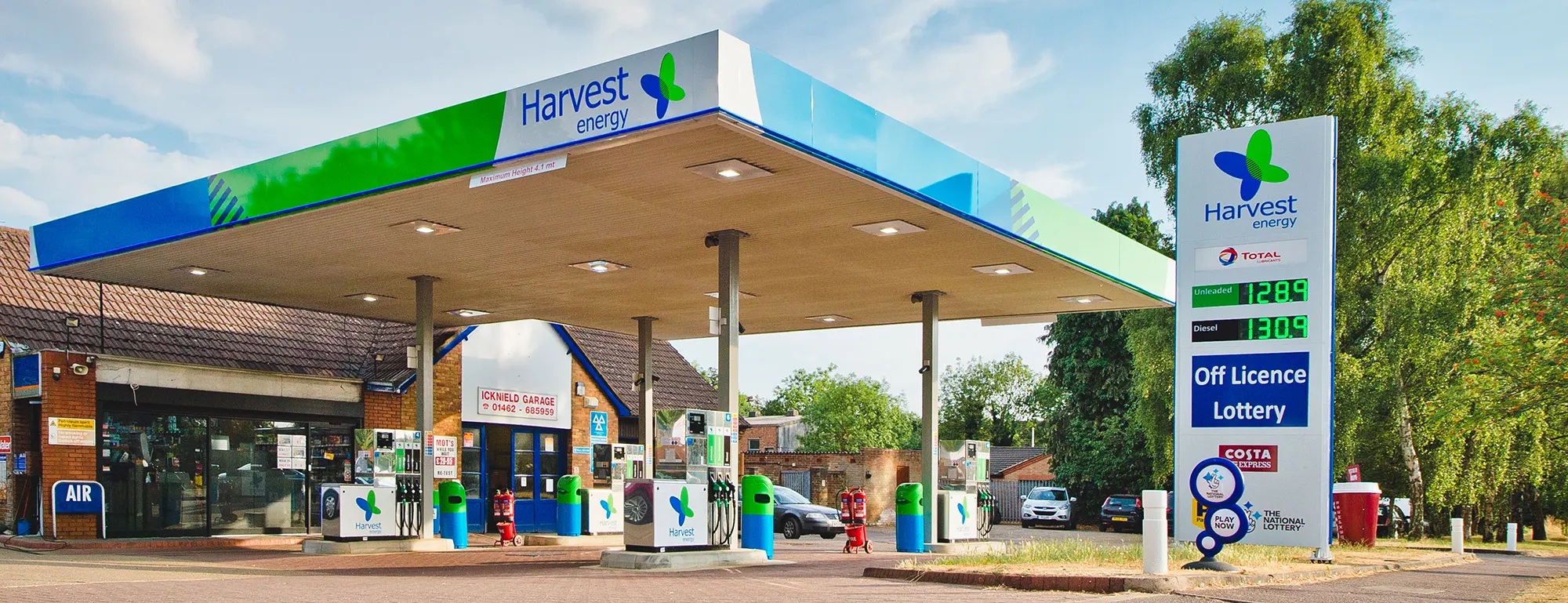 A Harvest Energy forecourt with the branded canopy, fuel pumps and service station retail area.